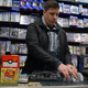 Daniel Mastin prepares a Nintendo 64 console bundle at Video Games New York. Photo: Cecilia D’Anastasio/Kotaku
